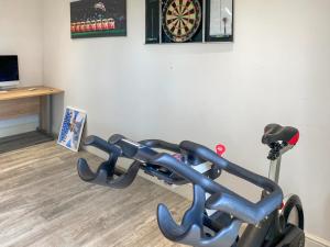 an exercise bike in a room next to a wall at Wysteria, North Lodge in Rusper