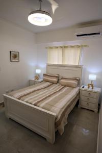 a bedroom with a large bed and two night stands at Amazing 2BR apartment near the airport in Los Frailes