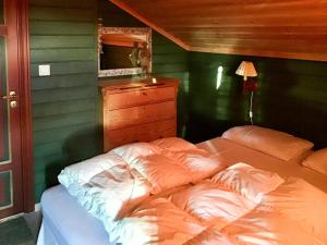 a bed in a room with a green wall at Spacious Family Cabin With Views In Hafjell in Hunder