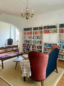 a living room with book shelves filled with books at Historic Manor House In Stettiner Haff Nature Park in Neuensund +32 photos