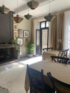 a living room with two tables and a fireplace at Dreamhome B&B Limoux in Limoux