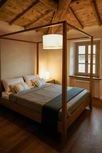 a bedroom with a canopy bed in a room at Stone Villa With Panoramic Pool in Bibbiena