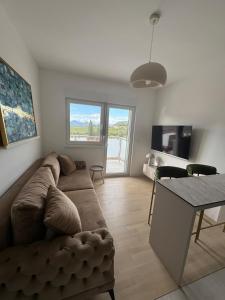 a living room with a couch and a table at Apartman Katamar in Ljubuški +26 photos