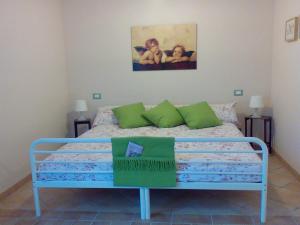 a bedroom with a blue bed with a painting on the wall at B&B RoLu in Prima Porta