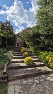 a set of stone steps in a garden with flowers at Roques Grosses in Santa María de Palautordera