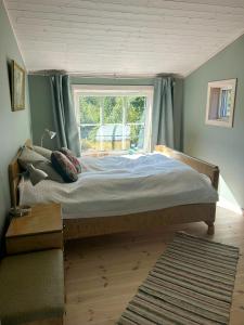 a large bed in a room with a window at Idyllic Farm With Access To Boathouse And Jetty in Mandal