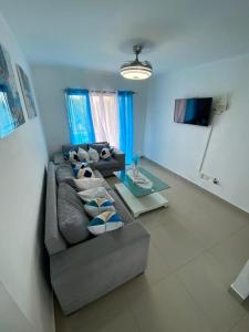 a living room with a couch and a table at Beautiful apartment near STGO airport in Santiago de los Caballeros