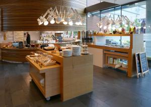 a restaurant with a counter with food on it at Hotel Udens Duyn in Uden