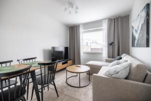 a living room with a couch and a table at Santas Arctic Aurora in Rovaniemi