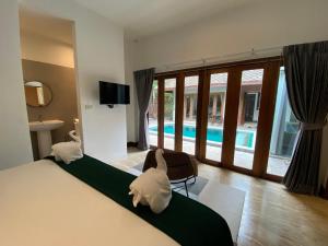 a hotel room with a bed and a swimming pool at Baan Khao Hua Jook in Chaweng