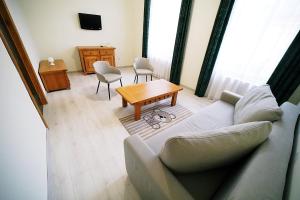 a living room with a couch and a table at Pensiunea Central in Reghin