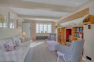 a living room with a couch and chairs in it at Church Cottage in Burford