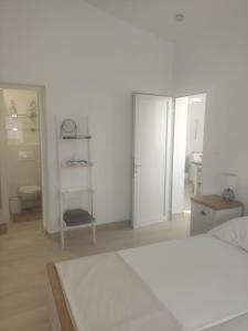 a white bedroom with a bed and a closet at Ferienhaus Bozena Appartment 4 in Vrsar +14 photos