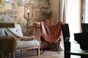 a living room with a chair and a lamp at La Maison de Marguerite in Montbrun-les-Bains
