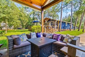 a couch sitting on a patio with a table at Lake Livingston Retreat with Firepit, Fishing, and Game Room in Livingston