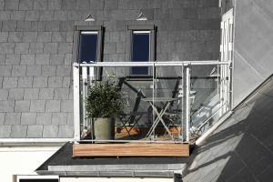 a balcony with a table and a potted plant at Boutique Hotel Hans in Copenhagen