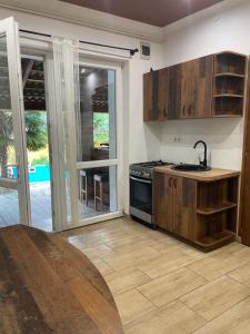 a kitchen with a sink and a stove at Hacienda Apartman in Békéscsaba