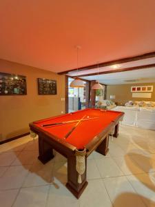 a ping pong table in a room with at Pousada Ferradura Boutique in Búzios