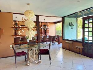 a dining room with a glass table and chairs at Pousada Ferradura Boutique in Búzios