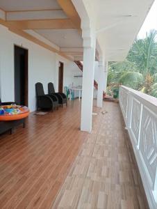 a living room with chairs and a wooden floor at Bulls residence seaview in Toledo City