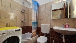 a bathroom with a washing machine and a sink at Apartmani Igrane 3 in Igrane +46 photos