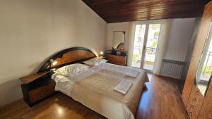 a bedroom with a large bed and a mirror at Apartmani Igrane 3 in Igrane