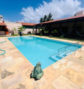 a rock in the middle of a swimming pool at Villa AFRICA-Zimmer Praia-Praia de Cumbuco in Caucaia