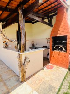 a kitchen with an outdoor kitchen with a fireplace at Villa AFRICA-Zimmer Praia-Praia de Cumbuco in Caucaia +9 photos