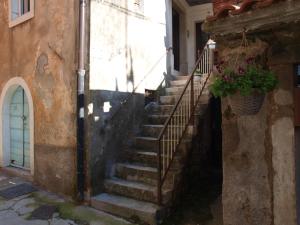 a staircase leading up to a building with a plant at Apartments Bea in Lovran