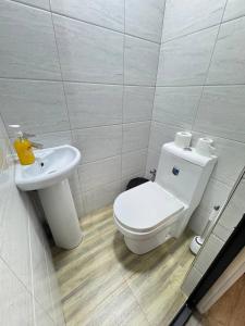 a bathroom with a toilet and a sink at Generator Tashkent Hostel in Tashkent +17 photos