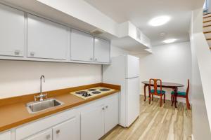 a kitchen with white cabinets and a table at Westwind Estate Apt 6 Mi to Dtwn Spartanburg in Woodfield