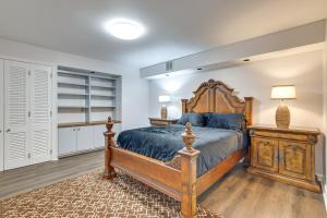 a bedroom with a large wooden bed and a lamp at Westwind Estate Apt 6 Mi to Dtwn Spartanburg in Woodfield