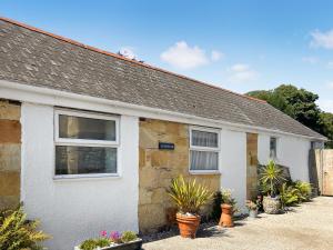 a house with potted plants in front of it at Sunrise in St Austell +9 photos