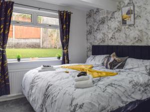 a bedroom with a bed with towels on it at West Park House in Penwortham