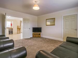 a living room with a couch and a flat screen tv at 4 Dawson Court - Uk33414 in Mablethorpe