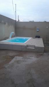 a large swimming pool in a parking lot at Casa Village do Sol in Guarapari