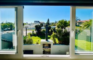 a view from a window of a building with palm trees at Boardrooms Kite Accommodation in Cape Town +20 photos