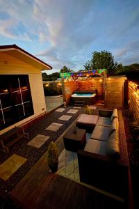a rooftop patio with a couch and a pool at Wellness bungalow with jacuzzi &sauna&private garden near Amsterdam in Vijfhuizen