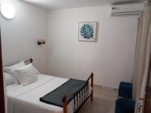 a bedroom with a bed and a blue chair at Villa sacre Cœur in Dakar