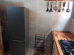 a kitchen with a refrigerator and a stove and utensils at Villa sacre Cœur in Dakar +5 photos