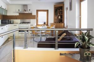 a kitchen and living room with a couch and a table at Casa Delia in Longarone