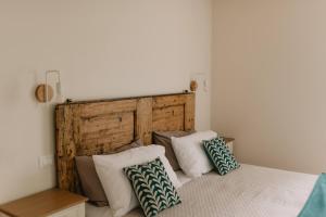 a bedroom with a bed with pillows on it at Tenuta Malvolti - Al Vecchio Convento in San Fior di Sopra