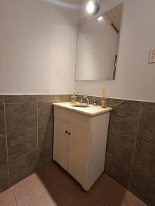 a bathroom with a sink and a mirror at Habegger Suites Centro Reconquista in Reconquista