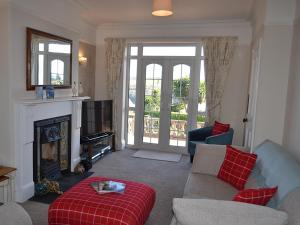 a living room with a couch and a fireplace at Riverview in Fowey