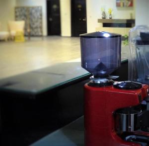 a blender sitting on top of a red fire hydrant at بوابة الصحافة للشقق المخدومة in Riyadh +27 photos