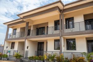 a building with balconies on the side of it at KiNaO in Bulindo