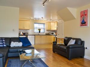 a living room with a couch and a table at 1 Kirkby Cottages in Sheriff Hutton