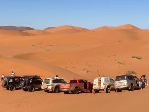 a group of cars parked in the desert at Porte De Sahara Ouzina in Ouzina +53 photos