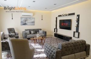 a living room with two couches and a tv at Modern Villa 1 min from Southpark Mall at Madinaty in Madinaty