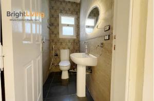 a bathroom with a sink and a toilet at Modern Villa 1 min from Southpark Mall at Madinaty in Madinaty +21 photos
